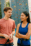 A male and female socialising in a climbing wall facility.